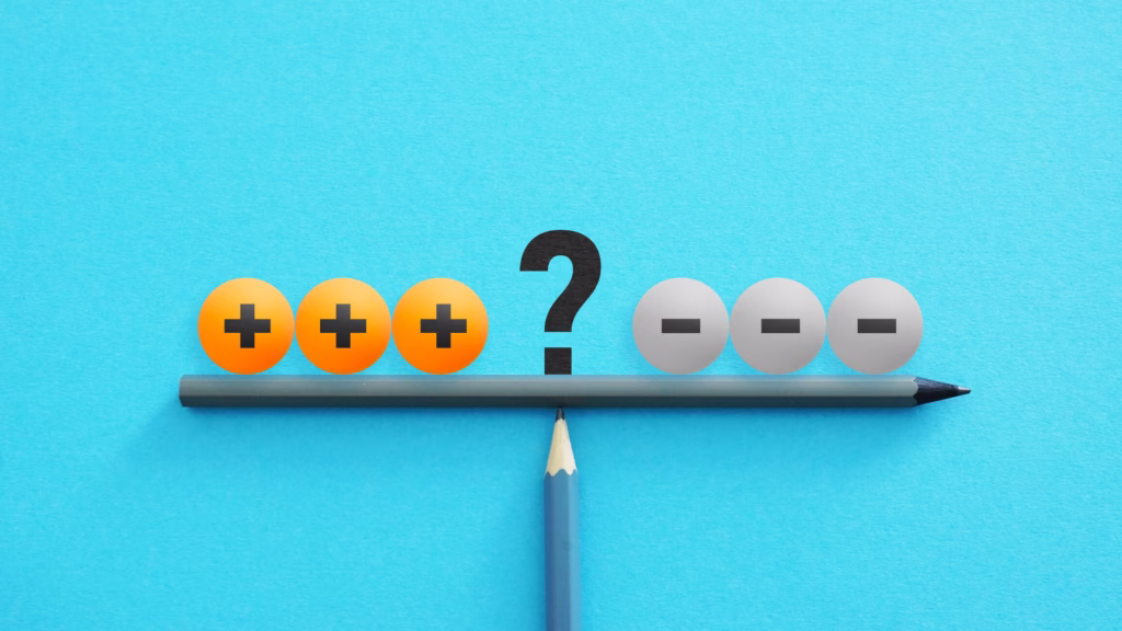 2 pencils are balanced one on top of the other, with blocks on either side representing pros, cons, and the balance between them.