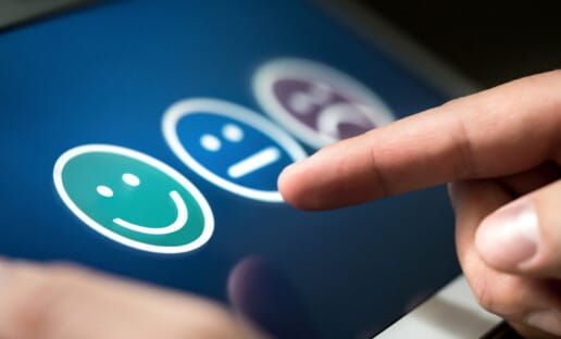 close up of finger leaving a positive review on tablet