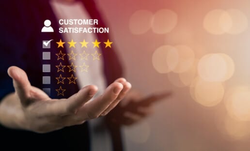 graphic of hand holidng customer satisfaction stars