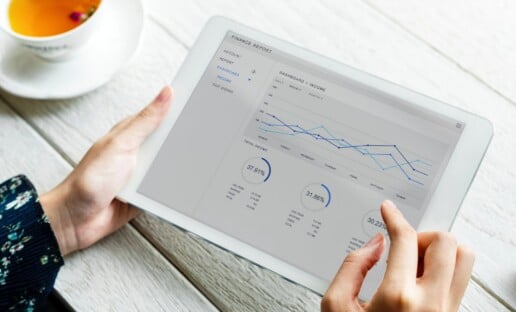 person holding a tablet showing a customer experience dashboard with interactive data