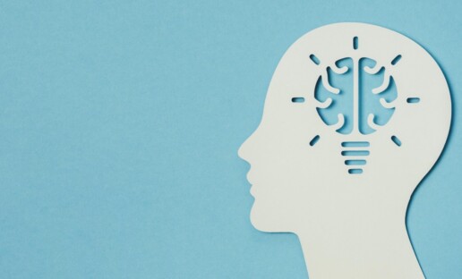 a persons head with a lightbulb shaped as a brain