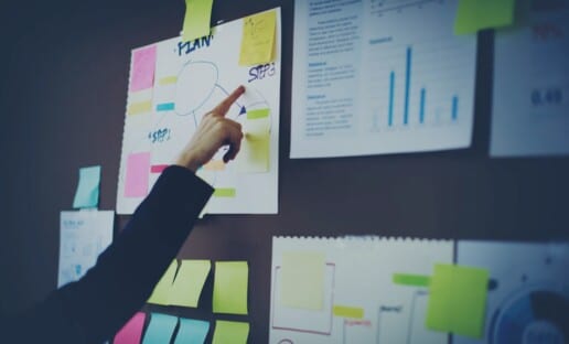 person pointing to a customer journey map to gain deeper insights about the customer experience after a journey map questionnaire