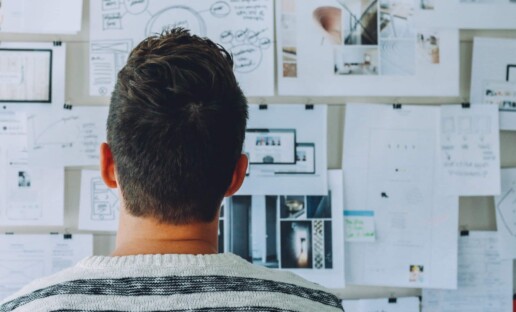 man looking at data after learning how to write good survey questions