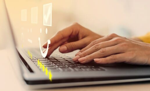 person typing on a keyboard taking an NPS survey