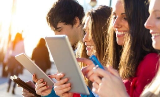 group of customers taking an Interaction Metrics survey on phones and tablets