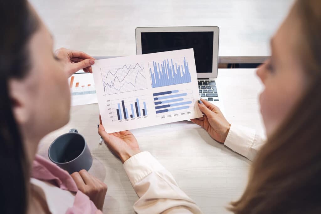 two CX analysts reviewing data and improving customer experience metrics